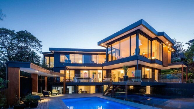 Modern clubhouse with a pool at dusk